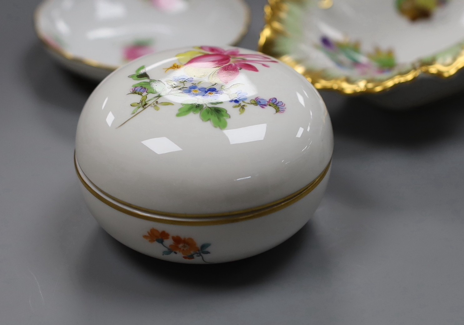 Two Meissen boxes with covers and a dish, two Herend dishes and an enamel on copper scent bottle